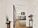 An open doorway with hardwood floors provides a glimpse into a stylish living room at 230 Channings Lake Dr, Lawrenceville, GA 30043