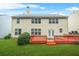 The back of the house has a wooden deck with french doors, lots of windows and a large, green, grassy backyard at 606 Hay Meadow, Acworth, GA 30102