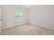A cozy bedroom with plush carpet, a bright window, and neutral decor at 606 Hay Meadow, Acworth, GA 30102