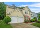 Charming two-story home featuring a manicured lawn and a two car garage at 606 Hay Meadow, Acworth, GA 30102