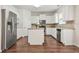 Well-lit kitchen featuring stainless steel appliances, white cabinets, and wood-look flooring at 606 Hay Meadow, Acworth, GA 30102