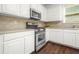 Kitchen with stainless steel oven, microwave and white cabinets with modern countertops at 606 Hay Meadow, Acworth, GA 30102