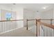 Carpeted upstairs landing with wood and white railings and windows to the outside at 606 Hay Meadow, Acworth, GA 30102