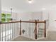 Upstairs landing with wood and white railings, carpeted floors and many bright windows at 606 Hay Meadow, Acworth, GA 30102