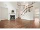 Bright living room with fireplace and a staircase leading to the second floor at 606 Hay Meadow, Acworth, GA 30102