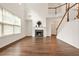 Bright living room with hardwood floors, a fireplace, and a stairway to the second floor at 606 Hay Meadow, Acworth, GA 30102