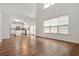 Spacious living room with bright windows offering natural light and hardwood floors, and view of a modern kitchen at 606 Hay Meadow, Acworth, GA 30102