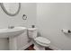 Elegant powder room featuring a pedestal sink, decorative mirror, and updated fixtures at 606 Hay Meadow, Acworth, GA 30102