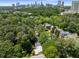 Aerial view of a residential area with mature trees and city skyline at 965 Heards Ferry Rd, Sandy Springs, GA 30328