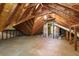 Unfinished attic space with exposed beams, offering potential for customization and storage at 965 Heards Ferry Rd, Sandy Springs, GA 30328
