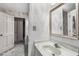 Classic bathroom featuring patterned wallpaper, a decorative mirror, and traditional fixtures at 965 Heards Ferry Rd, Sandy Springs, GA 30328