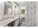 Charming bathroom with floral wallpaper, featuring bright light and plenty of counter space and storage at 965 Heards Ferry Rd, Sandy Springs, GA 30328