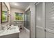 Bright bathroom with vintage-inspired features, including a vanity sink and bathtub with shower at 965 Heards Ferry Rd, Sandy Springs, GA 30328