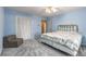 Comfortable bedroom featuring soft blue walls, plush carpeting, and a cozy floral-patterned bedspread at 965 Heards Ferry Rd, Sandy Springs, GA 30328