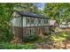 Charming two-story Tudor home featuring a brick facade and decorative wood trim surrounded by mature trees at 965 Heards Ferry Rd, Sandy Springs, GA 30328