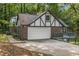 Charming exterior view of the home with a two-car garage and a quaint upper deck at 965 Heards Ferry Rd, Sandy Springs, GA 30328