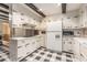 This kitchen features tiled floor, white cabinetry and countertops, and modern appliances at 965 Heards Ferry Rd, Sandy Springs, GA 30328