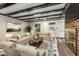 Inviting living room featuring exposed beam ceilings, fireplace, and a seamless view into the sunroom at 965 Heards Ferry Rd, Sandy Springs, GA 30328
