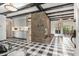 Open concept living space featuring fireplace, exposed ceilings, and view into sunroom and kitchen at 965 Heards Ferry Rd, Sandy Springs, GA 30328