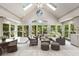 Bright and airy sunroom with vaulted ceilings, skylights, and a wall of windows overlooking the landscaped yard at 965 Heards Ferry Rd, Sandy Springs, GA 30328