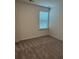 Carpeted bedroom featuring a window for natural light, and neutral walls at 1001 Limburg Dr, Hampton, GA 30228