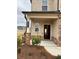 A close-up of a home's entrance featuring a column, brickwork and the house number at 1001 Limburg Dr, Hampton, GA 30228