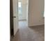 Open hallway leads to a carpeted bedroom with a window for natural light at 1001 Limburg Dr, Hampton, GA 30228