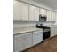 A kitchen featuring stainless steel appliances, including a microwave and a gas range at 1001 Limburg Dr, Hampton, GA 30228