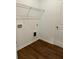 Spacious laundry room with wood floors, connections for a washer/dryer, and storage at 1001 Limburg Dr, Hampton, GA 30228