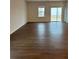 An open living room with wood floors and sliding doors leading to the outside at 1001 Limburg Dr, Hampton, GA 30228