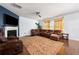Spacious living room with a fireplace, plush seating, and abundant natural light at 1612 Nations Trl, Riverdale, GA 30296