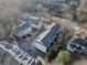 An aerial view showcasing the well-maintained townhomes with orderly parking and landscaping in a tranquil, wooded setting at 208 Wade Creek Rd, Alpharetta, GA 30009