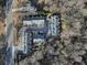 Overhead shot of townhomes in a wooded area, near a road, with ample parking spaces for residents and guests at 208 Wade Creek Rd, Alpharetta, GA 30009