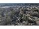 Aerial view of residential neighborhood with tree-lined streets and buildings in the distance, featuring multiple townhome communities at 208 Wade Creek Rd, Alpharetta, GA 30009