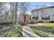 Outdoor patio area with brick fireplace, perfect for entertaining, set against a wooded backdrop at 208 Wade Creek Rd, Alpharetta, GA 30009