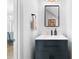Charming bathroom featuring a dark vanity with a white countertop and a sleek, modern mirror at 208 Wade Creek Rd, Alpharetta, GA 30009