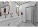 A sleek bathroom featuring dual sinks, modern lighting, and elegant design elements at 208 Wade Creek Rd, Alpharetta, GA 30009