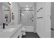 A luxurious bathroom displays stylish tiling in the shower-tub, complemented by a modern vanity at 208 Wade Creek Rd, Alpharetta, GA 30009