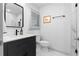 Modern bathroom featuring a sleek vanity, a frameless mirror, designer fixtures, and stylish marble-look tile at 208 Wade Creek Rd, Alpharetta, GA 30009
