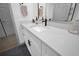 This bathroom is fitted with a white vanity, a marble countertop, and dark hardware at 208 Wade Creek Rd, Alpharetta, GA 30009
