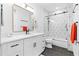 Modern bathroom features white cabinets, quartz counters, and geometric tile shower with black hardware at 208 Wade Creek Rd, Alpharetta, GA 30009