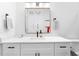 Bright bathroom with white cabinetry, quartz countertop, gold trimmed mirror, and matte black hardware at 208 Wade Creek Rd, Alpharetta, GA 30009