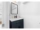 Bright bathroom featuring a dark vanity with a white countertop and a sleek, modern mirror at 208 Wade Creek Rd, Alpharetta, GA 30009