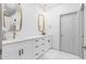 Bright bathroom featuring double sinks, gold trimmed mirrors, white cabinets, and modern hardware at 208 Wade Creek Rd, Alpharetta, GA 30009