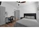 A well-lit bedroom showcases a desk, comfy bed, and a ceiling fan at 208 Wade Creek Rd, Alpharetta, GA 30009