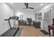 Spacious bonus room complete with a treadmill, piano, desk, and chair at 208 Wade Creek Rd, Alpharetta, GA 30009