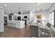 Open floor plan features a modern kitchen open to a dining area with contemporary lighting and ample seating at 208 Wade Creek Rd, Alpharetta, GA 30009