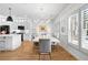 Elegant dining room with white cabinets, modern light fixture, and an open concept to the kitchen at 208 Wade Creek Rd, Alpharetta, GA 30009