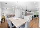 Open concept dining room and kitchen with breakfast bar, modern chandelier, and stainless steel appliances at 208 Wade Creek Rd, Alpharetta, GA 30009