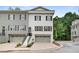 Beautiful townhome featuring a two-car garage, a neatly kept lawn, and easy access to local roads at 208 Wade Creek Rd, Alpharetta, GA 30009